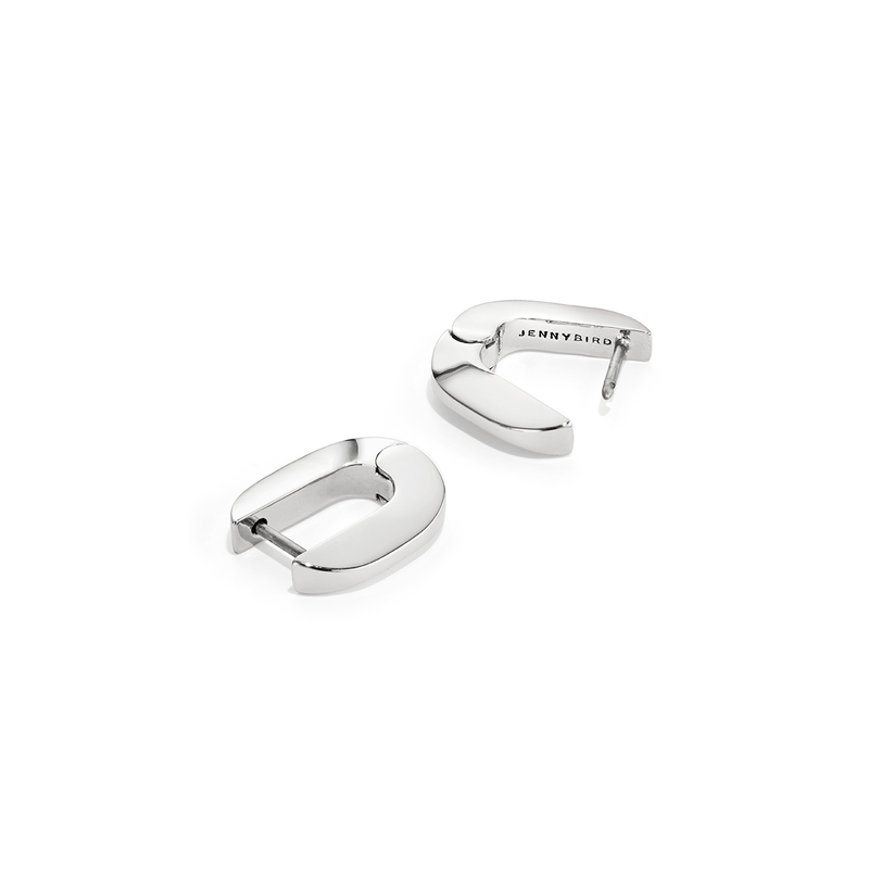 Teeni Tony by Jenny Bird silver huggie earrings on a white background, highlighting the sleek, high-polish finish.